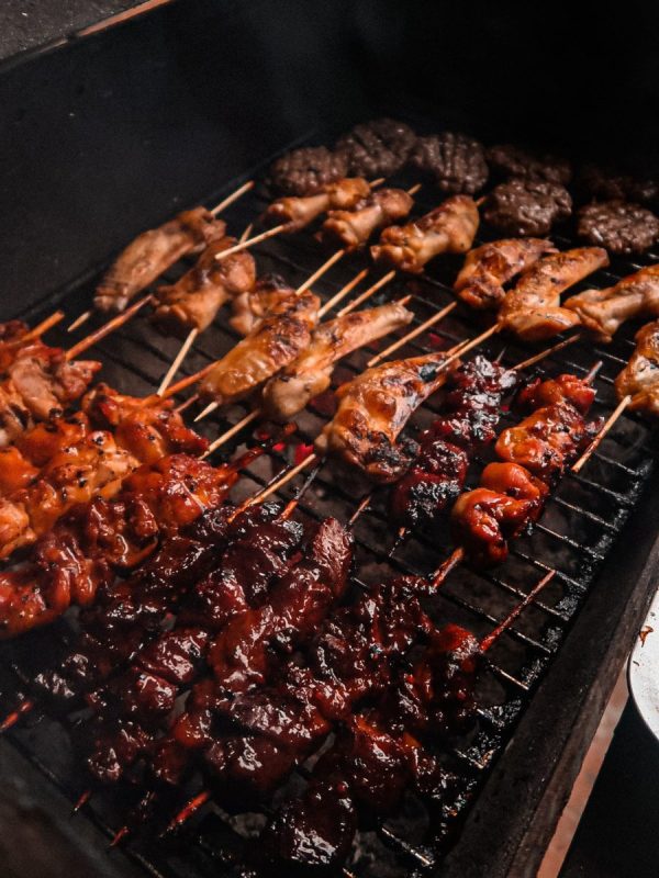 chicken kebabs on the braai grill with smoke rising